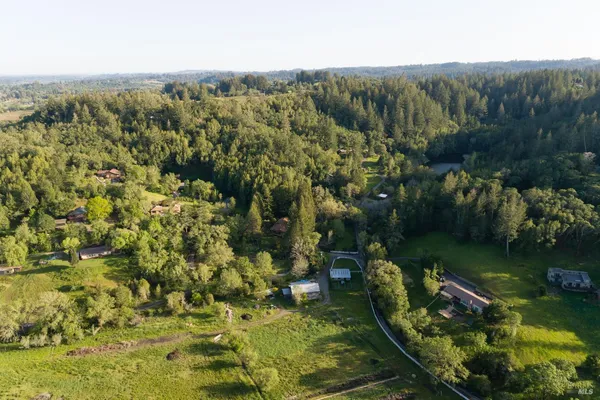 an aerial view of a houses with a yard