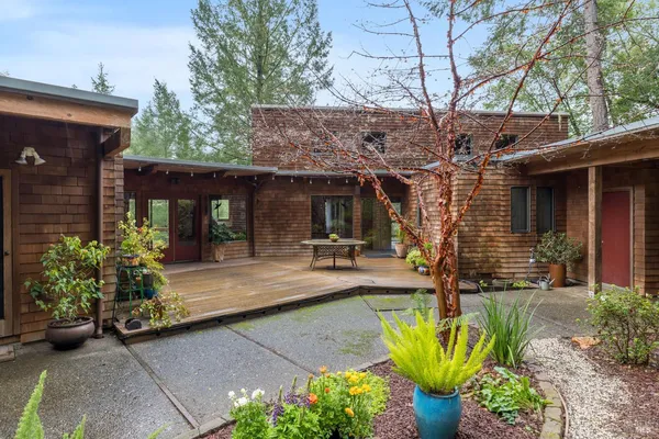 a view of a house with sitting area and potted plants