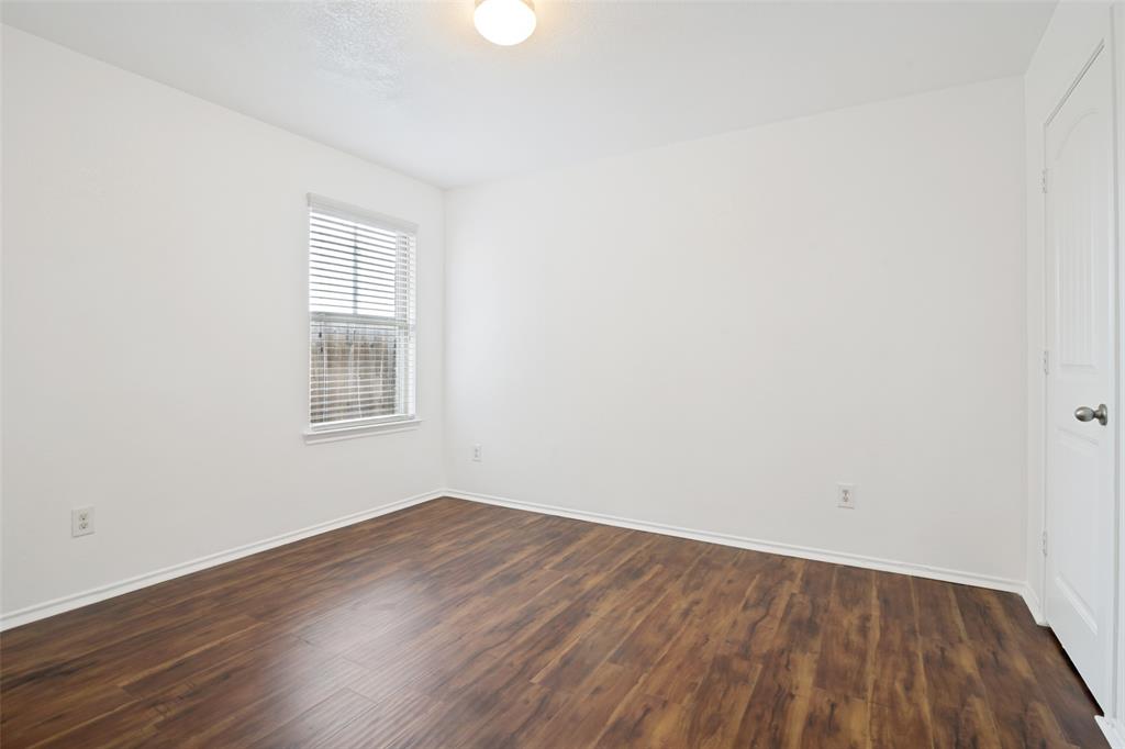 3415 Emerson Road Forney, TX 75126 - Photo 16 of 26 an empty room with wooden floor and windows