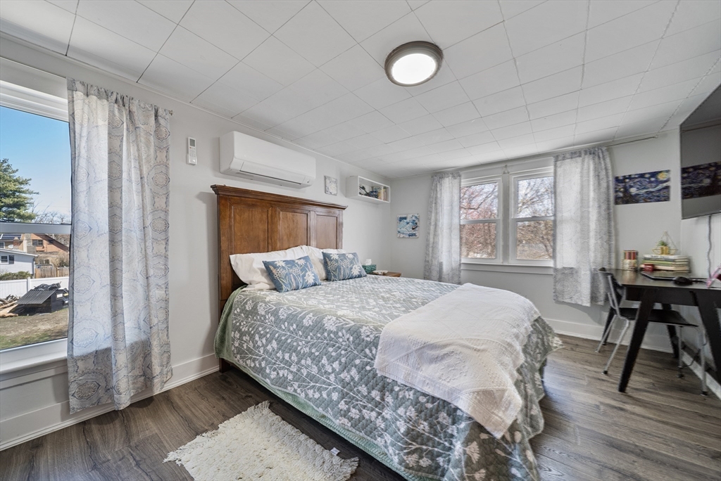 294 Whalom Road Lunenburg, MA 01462 - Photo 20 of 32 a bedroom with a bed and wooden floor