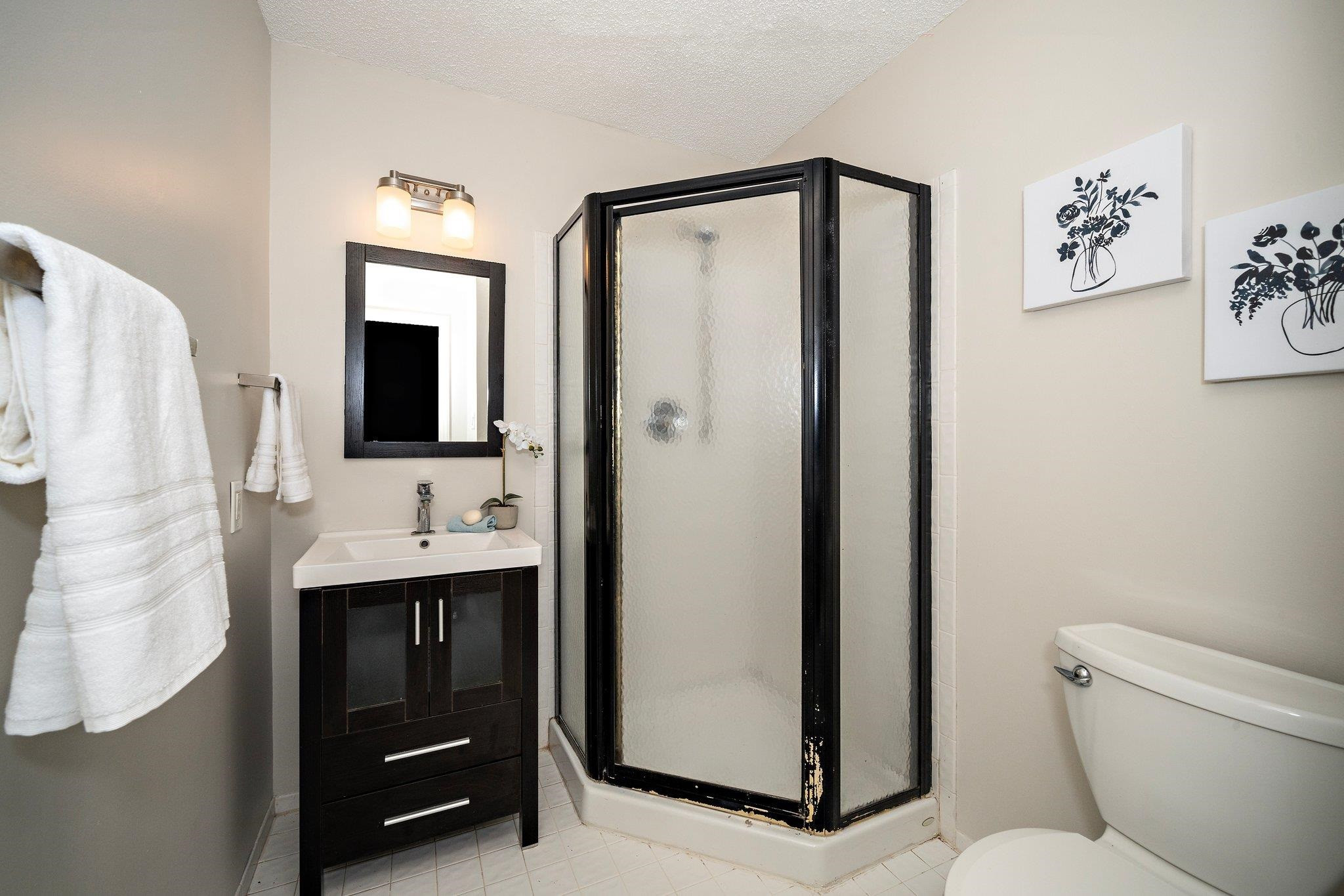 6304 Rushingbrook Drive Raleigh, NC 27612 - Photo 12 of 51 a bathroom with a sink a toilet and shower