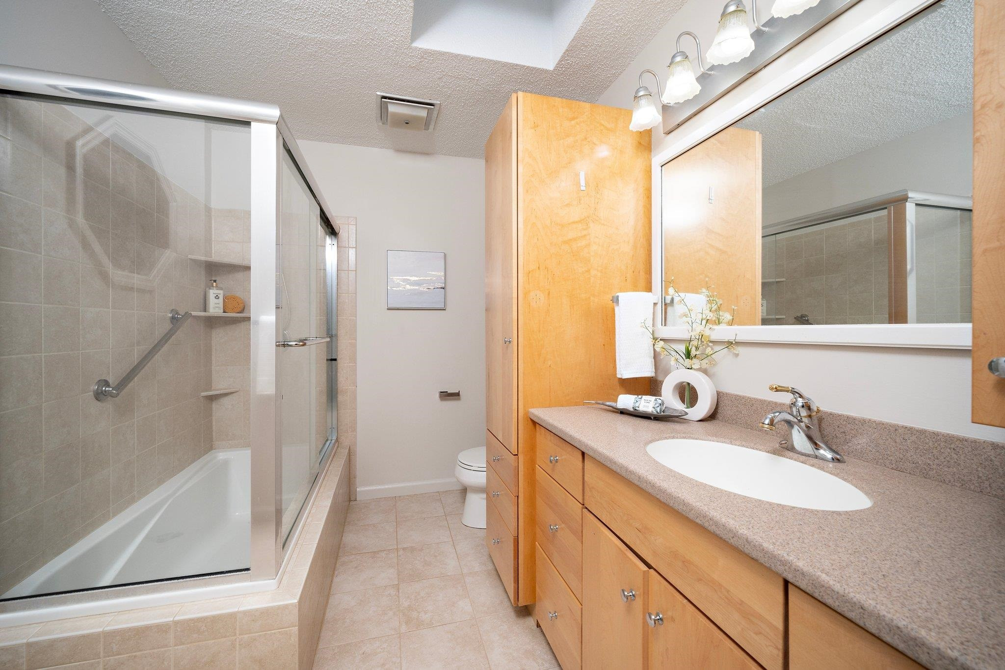 6304 Rushingbrook Drive Raleigh, NC 27612 - Photo 15 of 51 a bathroom with a granite countertop sink and a mirror