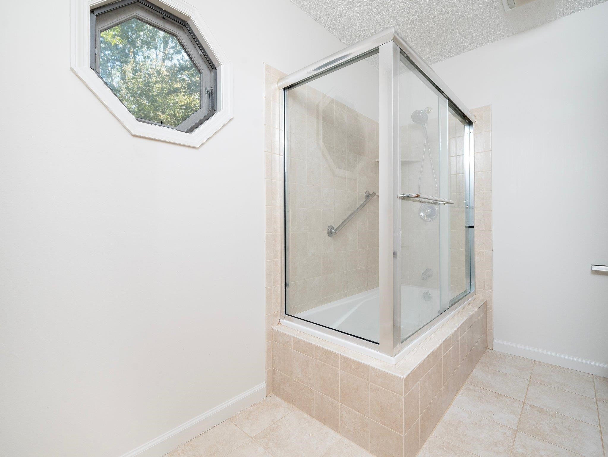 6304 Rushingbrook Drive Raleigh, NC 27612 - Photo 26 of 51 a bathroom with a glass shower door