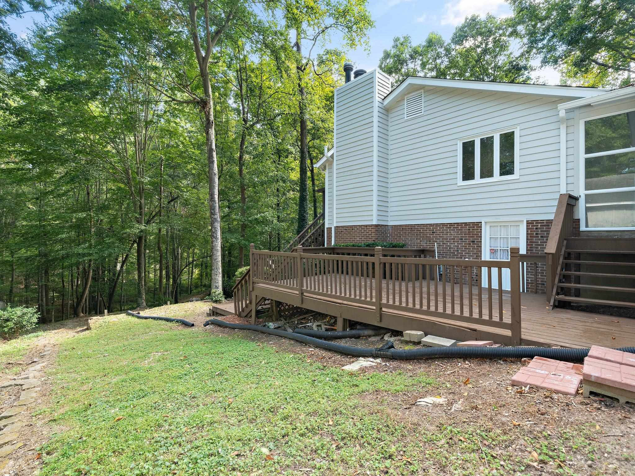 6304 Rushingbrook Drive Raleigh, NC 27612 - Photo 29 of 51 a view of backyard with wooden fence and a bench