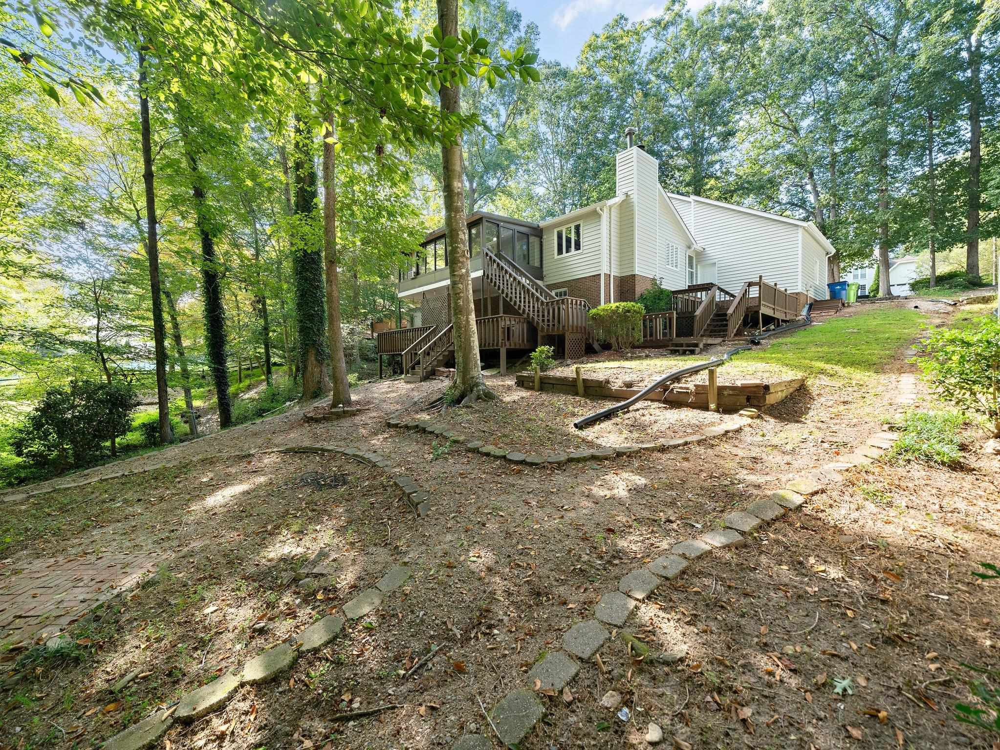 6304 Rushingbrook Drive Raleigh, NC 27612 - Photo 31 of 51 a view of a house with backyard and trees