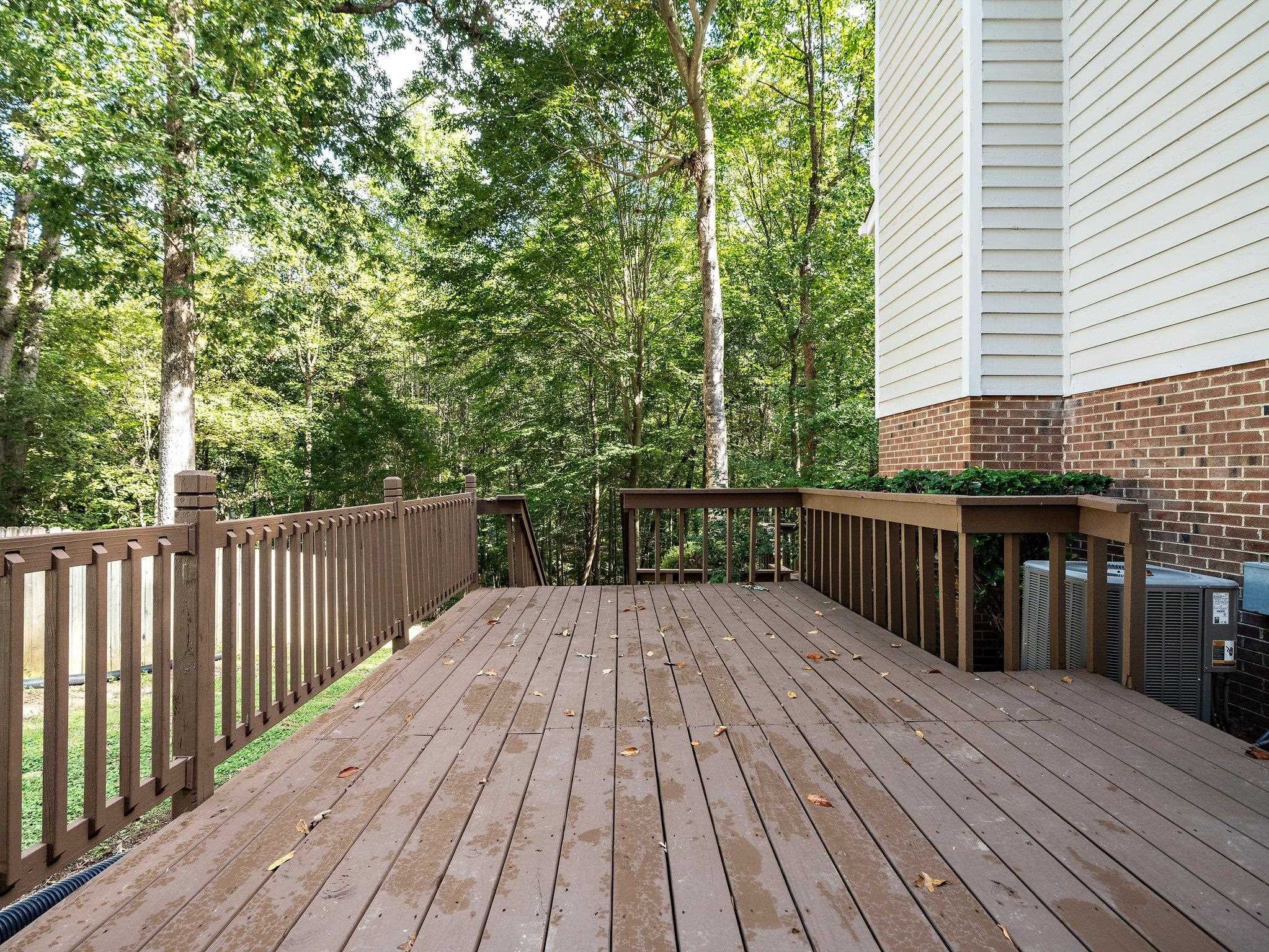 6304 Rushingbrook Drive Raleigh, NC 27612 - Photo 37 of 51 a balcony with wooden floor and trees