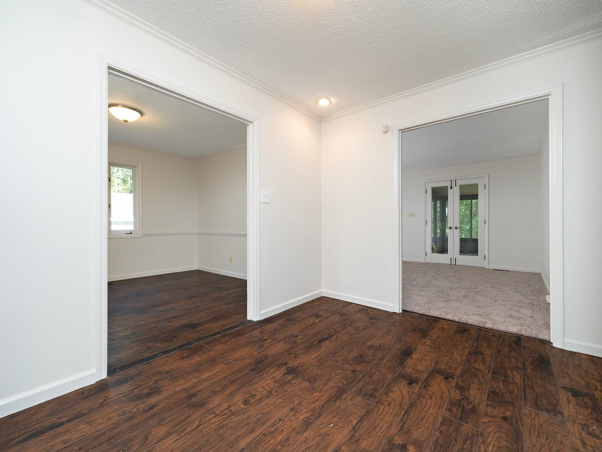6304 Rushingbrook Drive Raleigh, NC 27612 - Photo 39 of 51 an empty room with wooden floor and windows