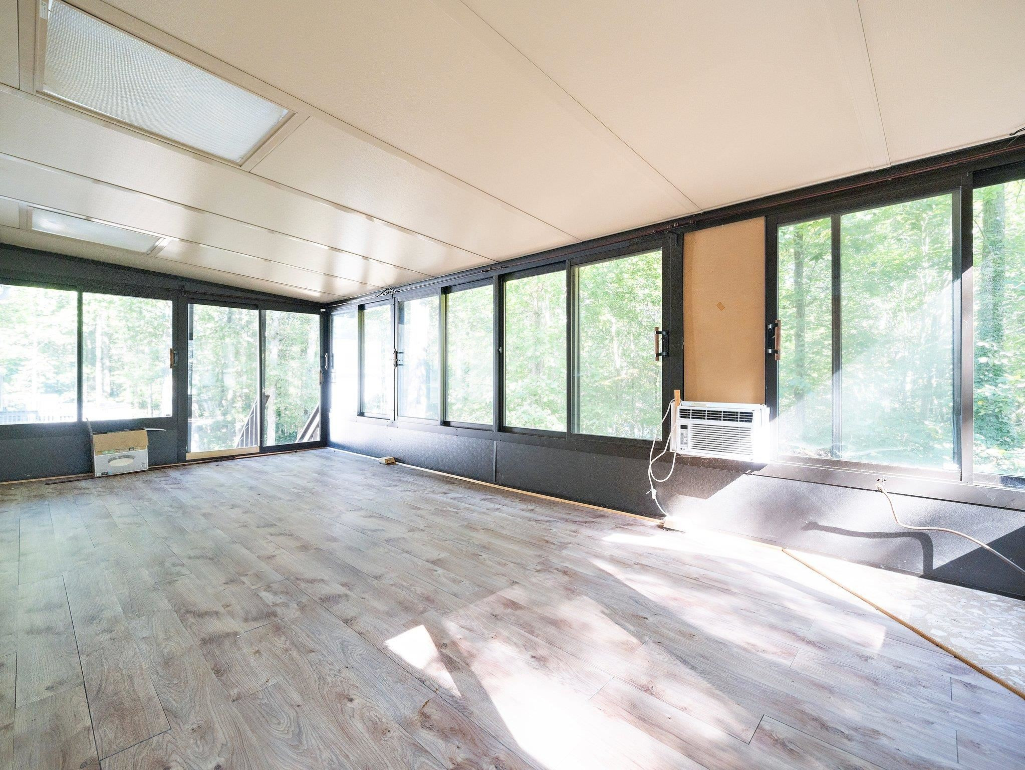 6304 Rushingbrook Drive Raleigh, NC 27612 - Photo 41 of 51 a view of an empty room with a large window with kitchen view