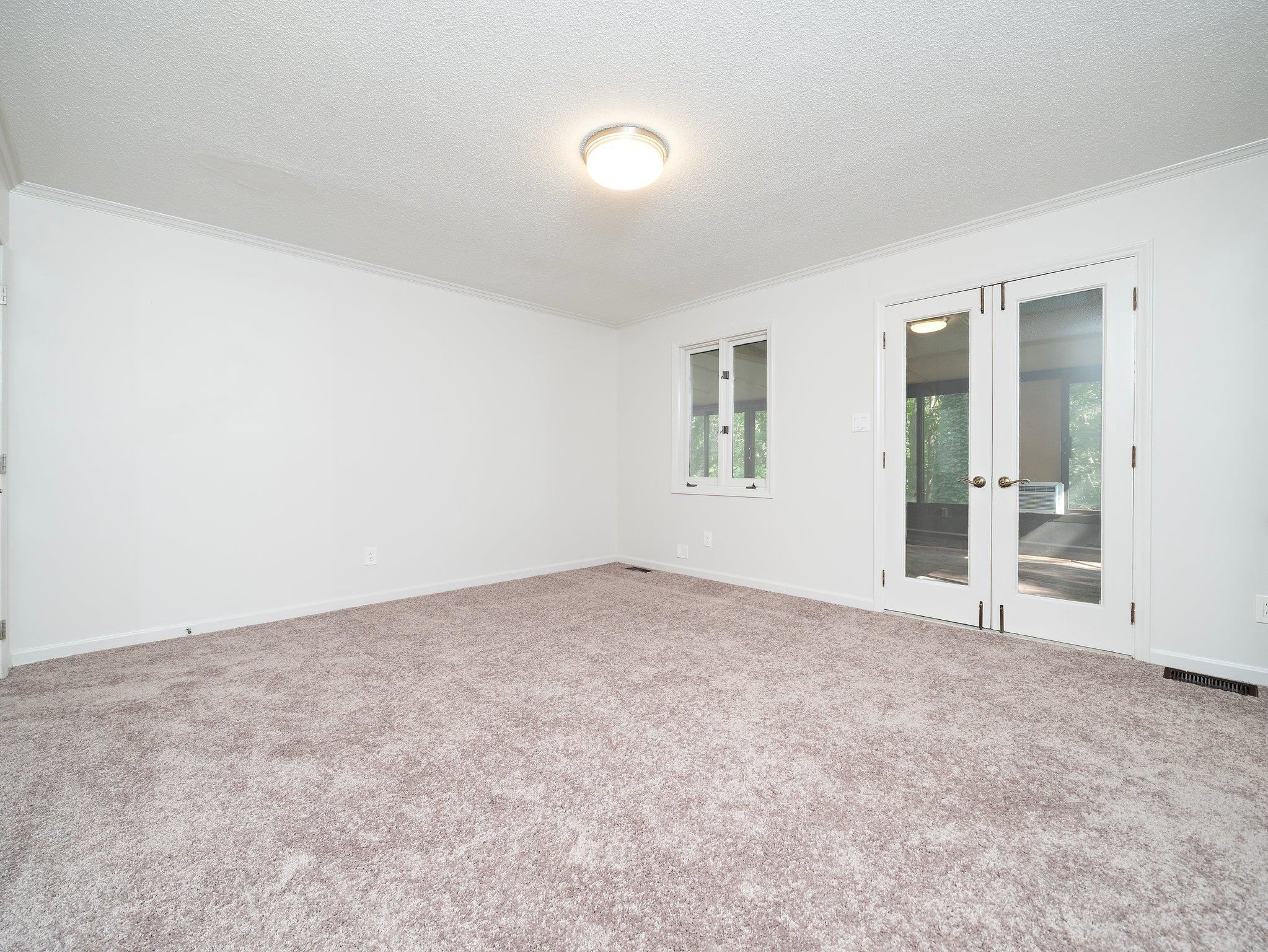 6304 Rushingbrook Drive Raleigh, NC 27612 - Photo 43 of 51 an empty room with windows and closet
