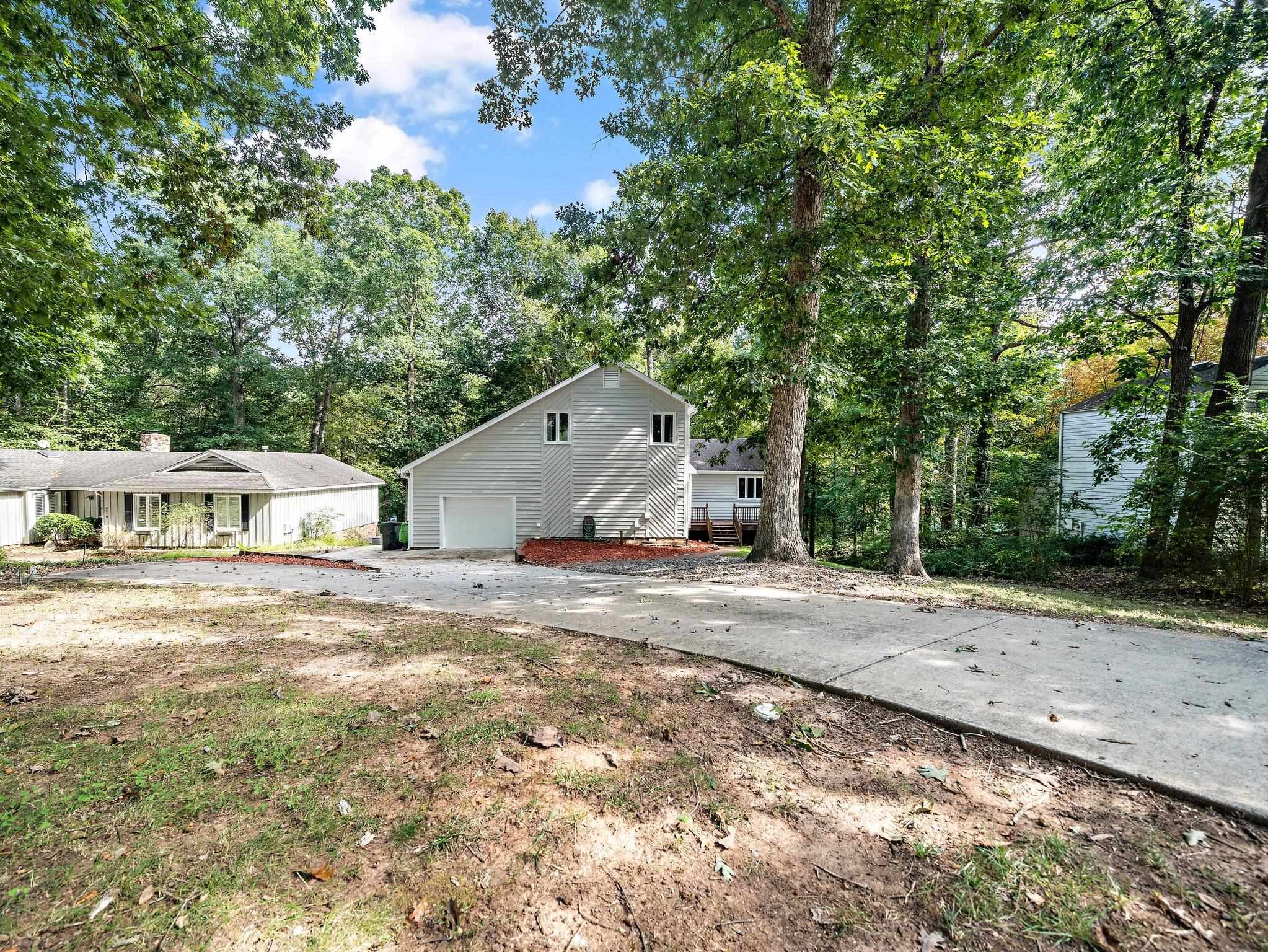 6304 Rushingbrook Drive Raleigh, NC 27612 - Photo 5 of 51 a front view of a house with a yard and trees