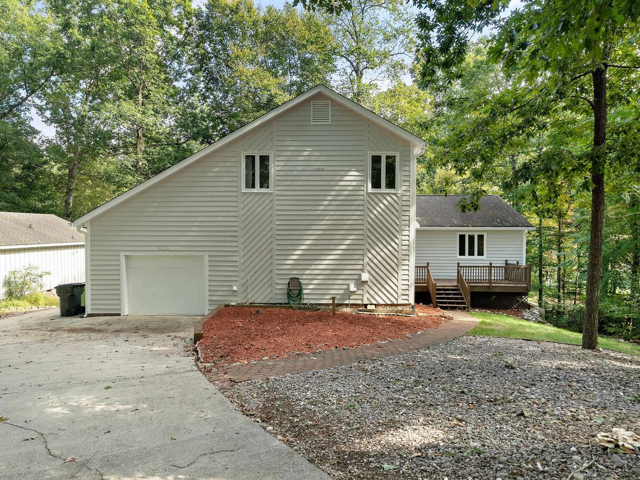 6304 Rushingbrook Drive Raleigh, NC 27612 - Photo 6 of 51 a front view of a house with a garden