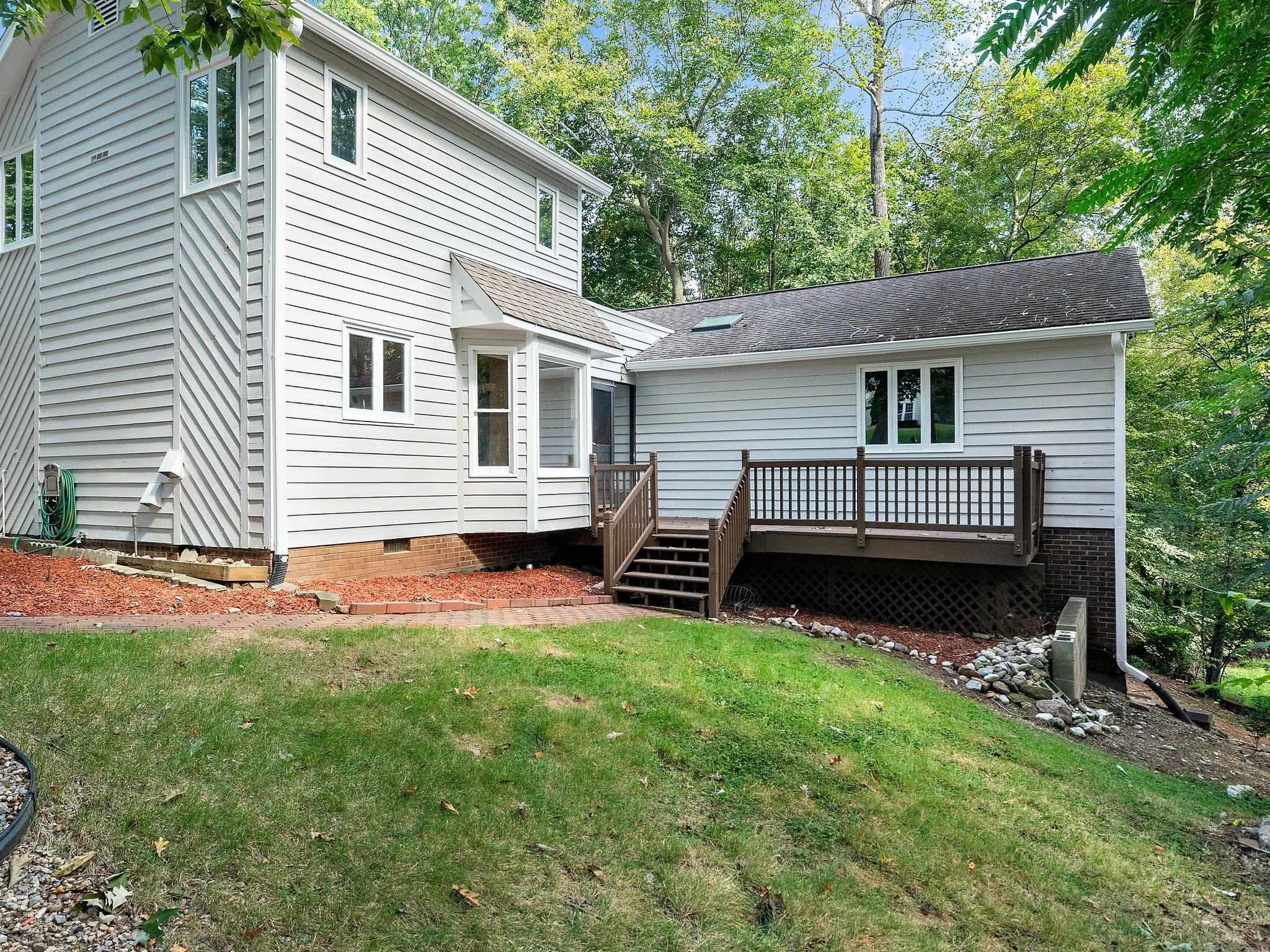 6304 Rushingbrook Drive Raleigh, NC 27612 - Photo 7 of 51 a front view of a house with a garden and deck