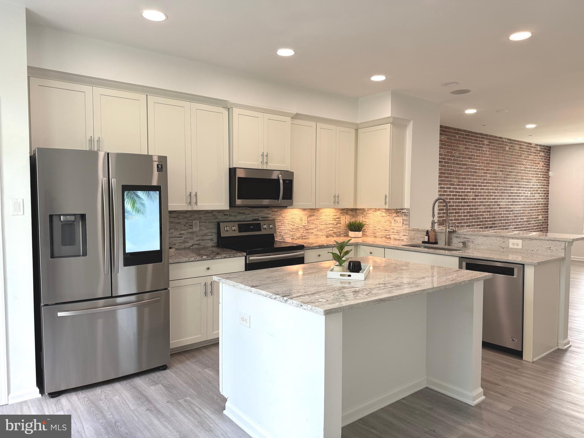 139 Streamview Drive Fredericksburg, VA 22405 - Photo 6 of 28 a kitchen with a sink stainless steel appliances and white cabinets