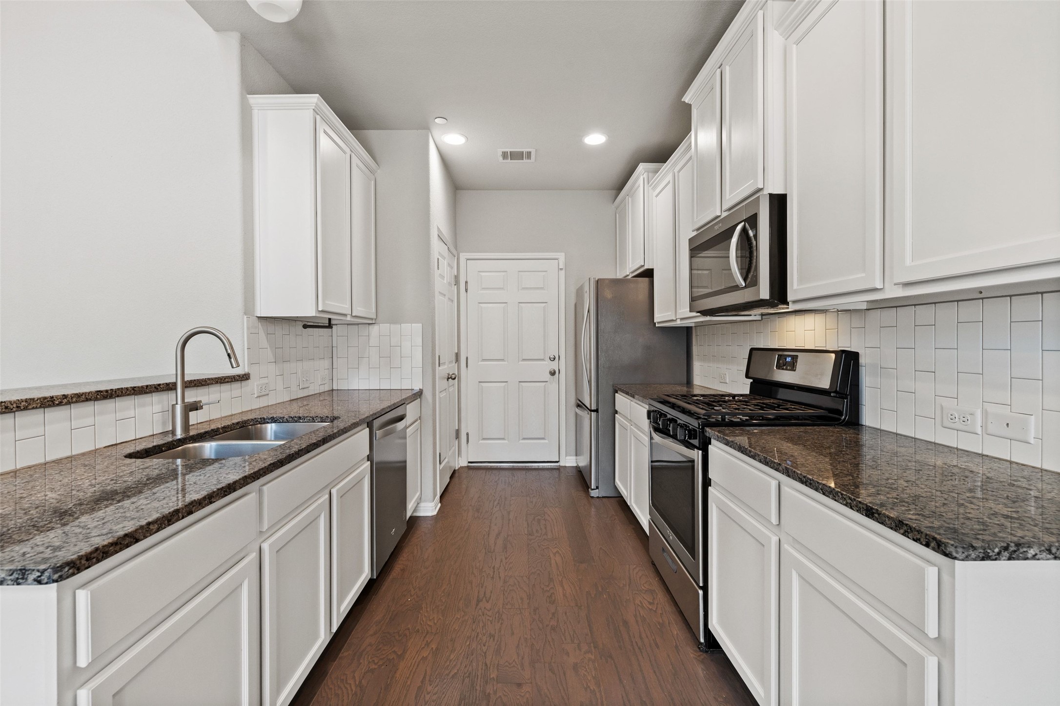 1615 Airedale Road Austin, TX 78748 - Photo 17 of 39 a kitchen with stainless steel appliances granite countertop a sink stove and cabinets