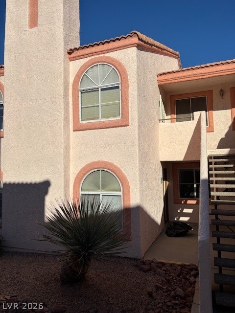 7570 West Flamingo Road, Unit 125 Las Vegas, NV 89147 - Photo 2 of 29 View of front of home featuring stucco siding and a tiled roof