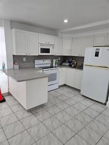 a kitchen with stainless steel appliances granite countertop a sink and a stove