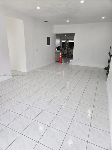 an empty room with furniture and natural light