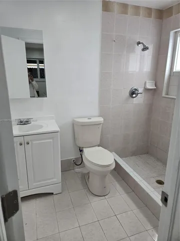 a bathroom with a toilet sink and shower