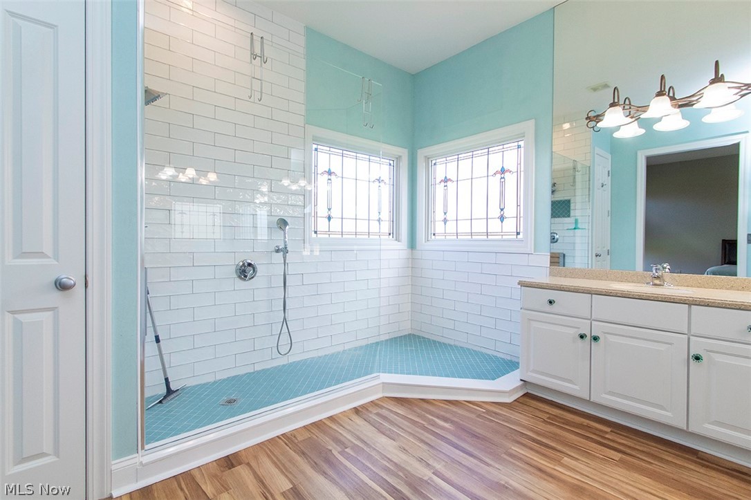 2201 Granger Road Medina, OH 44256 - Photo 17 of 34 Bathroom featuring a walk in shower, vanity, and light wood-style flooring
