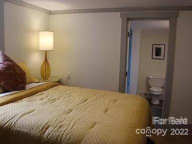 31 Banks Town Road Weaverville, NC 28787 - Photo 14 of 22 a bedroom with a bed and a lamp