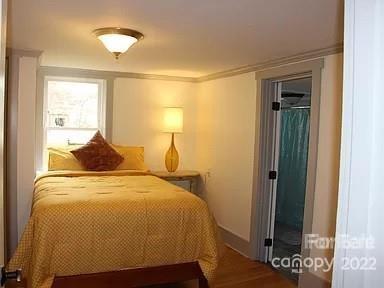 31 Banks Town Road Weaverville, NC 28787 - Photo 15 of 22 a bedroom with a bed and wooden floor