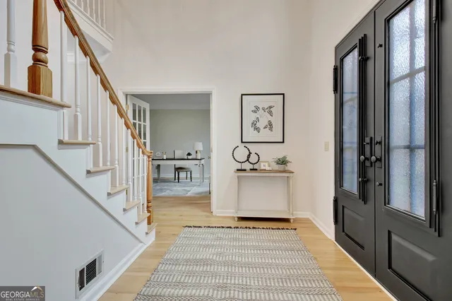 a living room with furniture a large window and a fireplace