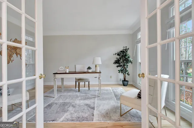 a living room with furniture and a large window with outer view