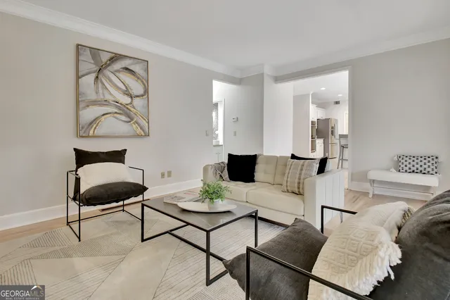 a kitchen with stainless steel appliances granite countertop white cabinets sink and a granite counter top