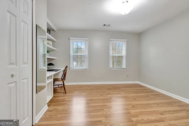 a view of a building with a flat screen tv and a car parked