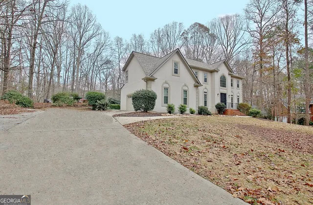 a view of staircase with lots of frames on wall and a window