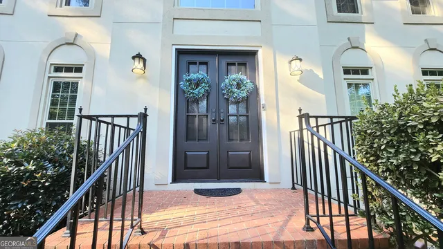 a view of entryway with wooden floor and stairs