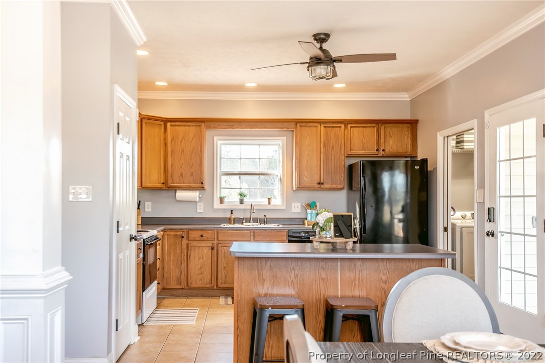 3577 Hayfield Road Wade, NC 28395 - Photo 12 of 47 a kitchen with a refrigerator a sink cabinets and a window