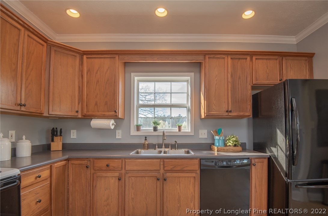 3577 Hayfield Road Wade, NC 28395 - Photo 17 of 47 a kitchen with stainless steel appliances granite countertop a refrigerator sink and cabinets