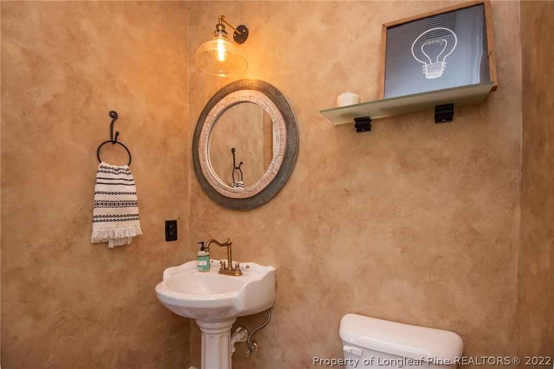 3577 Hayfield Road Wade, NC 28395 - Photo 19 of 47 a bathroom with a sink mirror and toilet
