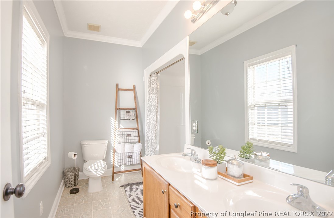 3577 Hayfield Road Wade, NC 28395 - Photo 23 of 47 a dining room with wooden floor and large windows