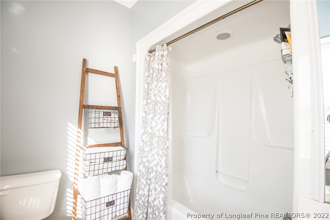 3577 Hayfield Road Wade, NC 28395 - Photo 24 of 47 a bathroom with a toilet and a shower