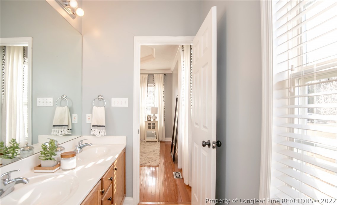 3577 Hayfield Road Wade, NC 28395 - Photo 25 of 47 a bathroom with a tub sink and mirror