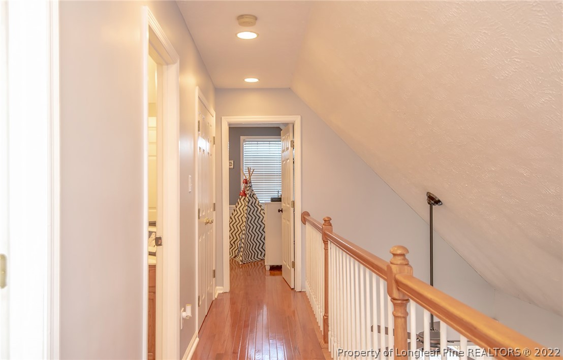 3577 Hayfield Road Wade, NC 28395 - Photo 28 of 47 a view of a hallway with wooden floor and staircase