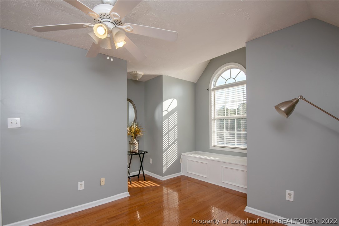 3577 Hayfield Road Wade, NC 28395 - Photo 29 of 47 an empty room with wooden floor fan and windows