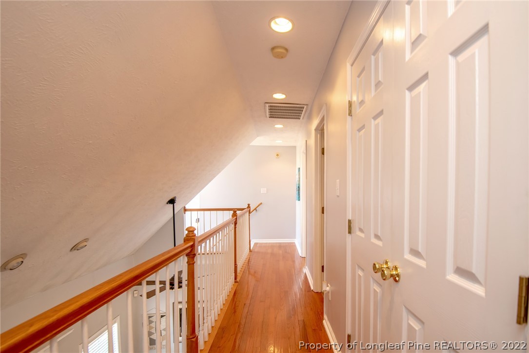 3577 Hayfield Road Wade, NC 28395 - Photo 35 of 47 a view of a hallway with wooden floor and staircase