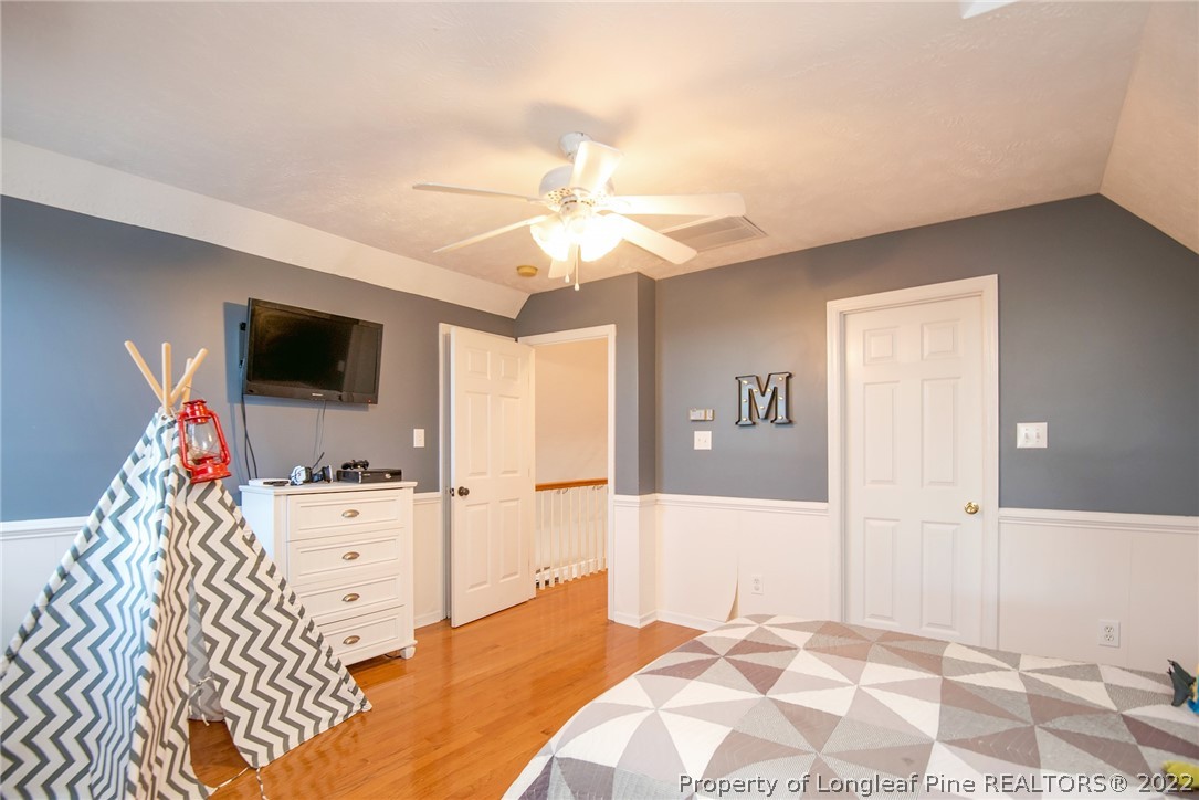 3577 Hayfield Road Wade, NC 28395 - Photo 36 of 47 a bedroom with a bed and flat screen tv