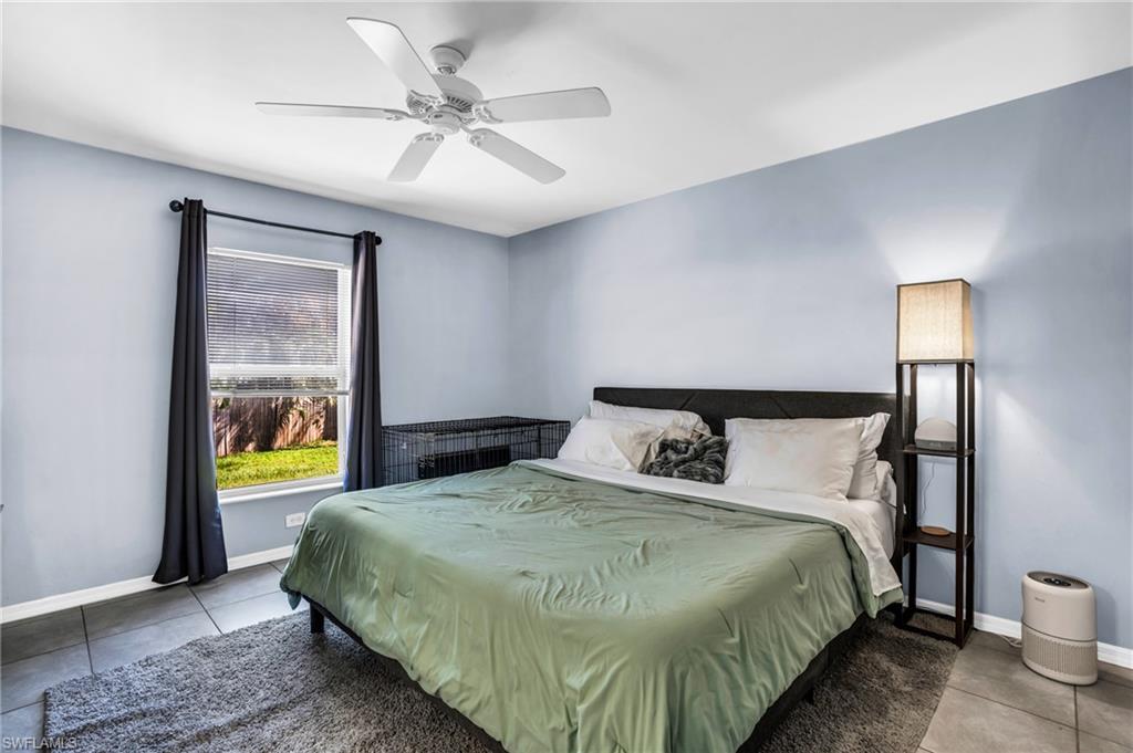 8069 Albatross Road Fort Myers, FL 33967 - Photo 13 of 21 Bedroom with tile patterned flooring and ceiling fan