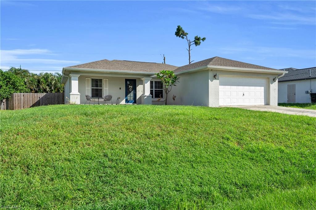 8069 Albatross Road Fort Myers, FL 33967 - Photo 2 of 21 Ranch-style home with a garage and a front yard
