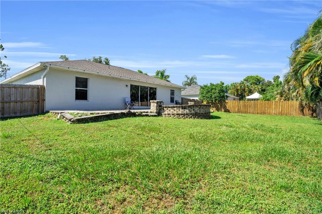 8069 Albatross Road Fort Myers, FL 33967 - Photo 21 of 21 Rear view of property with a lawn