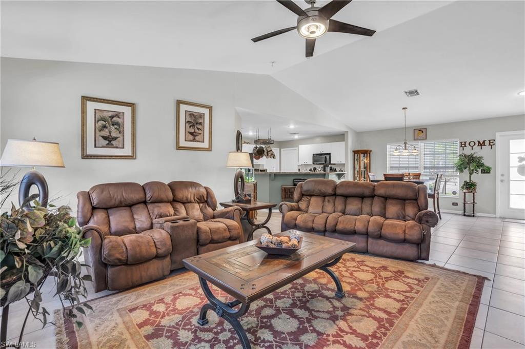 8069 Albatross Road Fort Myers, FL 33967 - Photo 3 of 21 Tiled living room featuring lofted ceiling and ceiling fan