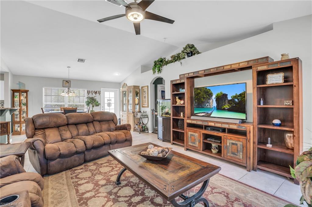 8069 Albatross Road Fort Myers, FL 33967 - Photo 4 of 21 Living room featuring ceiling fan, lofted ceiling, and light tile patterned floors