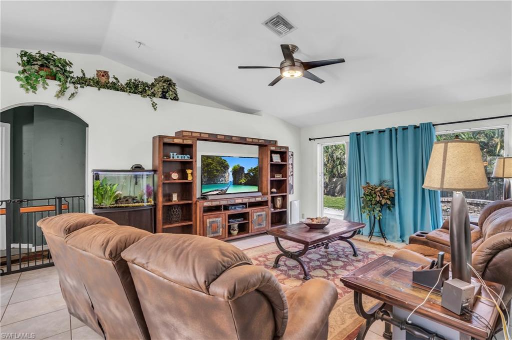 8069 Albatross Road Fort Myers, FL 33967 - Photo 5 of 21 Tiled living room with ceiling fan and lofted ceiling