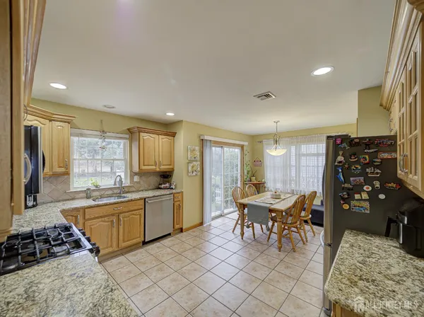 a kitchen with a table and chairs