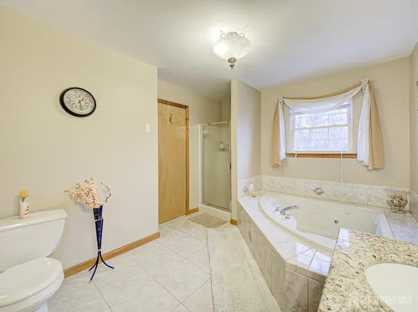 a bathroom with a tub sink and a toilet