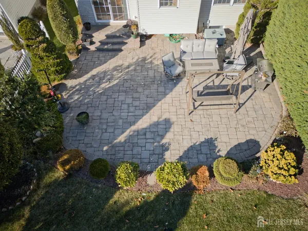 a aerial view of a house with a yard and potted plants
